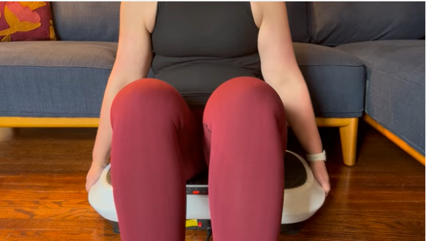 A woman sitting  on a vibration plate to help relieve her lipedema symptoms.